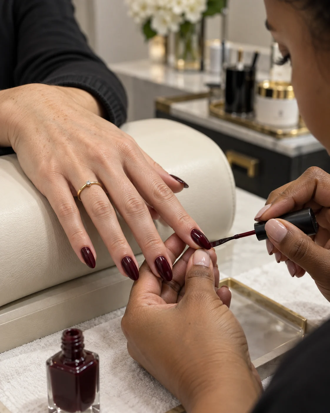 A polished burgundy manicure